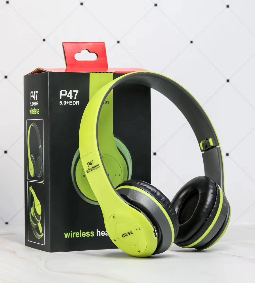 Green and black wireless headphones with P47 packaging on a white background