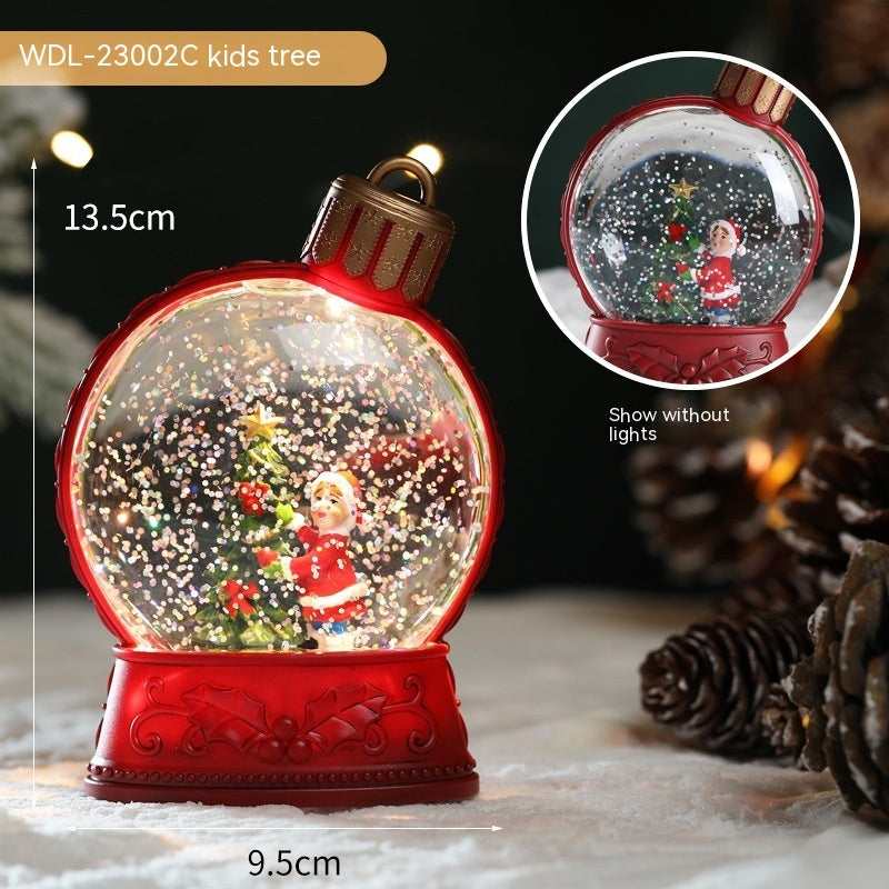 Red ornament-shaped snow globe with a Christmas scene inside, showing measurements and an inset of the scene without lights.
