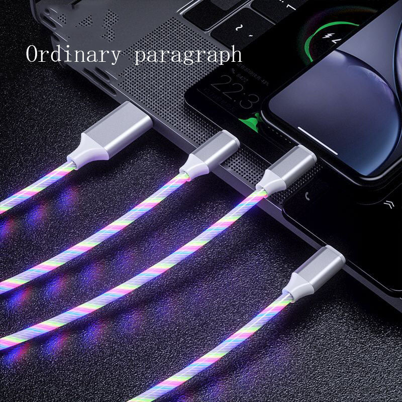 Multifunctional cable with colorful sheath connected to a laptop and phone on a dark surface.