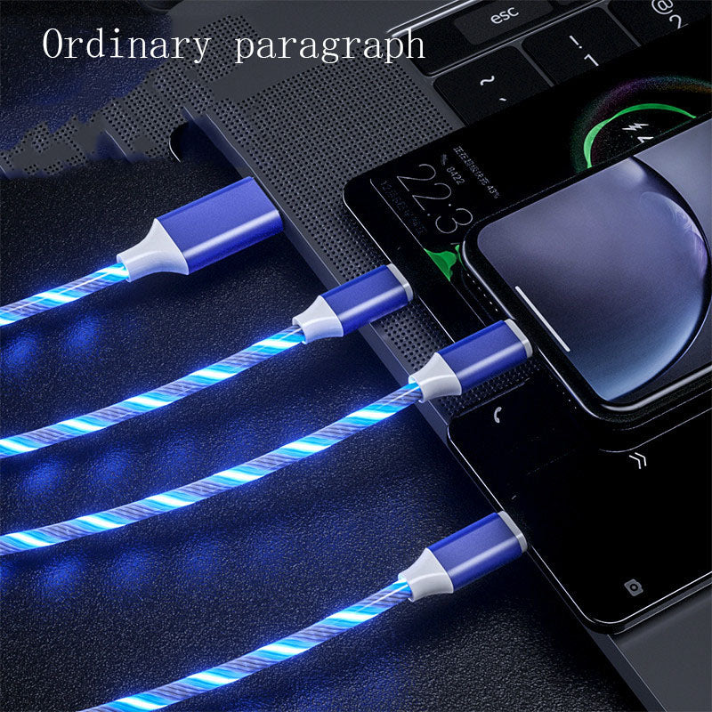Blue LED cable being used to charge a smartphone on a dark surface.