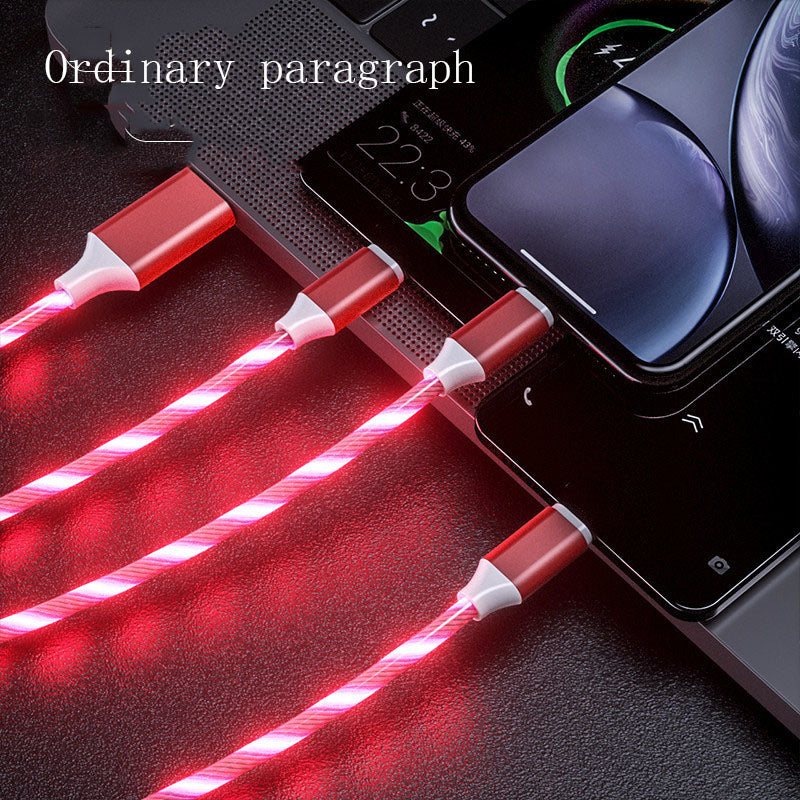 Red LED cable charging multiple electronic devices on a dark surface