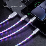 Multifunctional cable with colorful sheath connected to a laptop and phone on a dark surface.