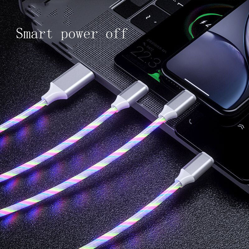 Multifunctional cable with colorful sheath connected to a laptop and phone on a dark surface.