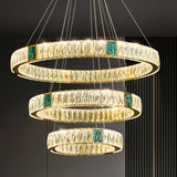 Three-tiered chandelier with crystal accents on a dark background
