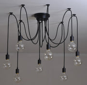 Modern chandelier with multiple hanging light bulbs on a plain background