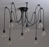 Modern chandelier with multiple hanging light bulbs on a plain background