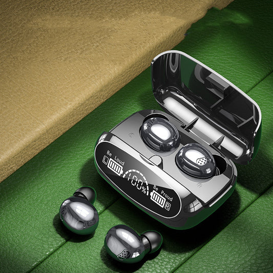 Wireless earbuds with charging case on a green surface