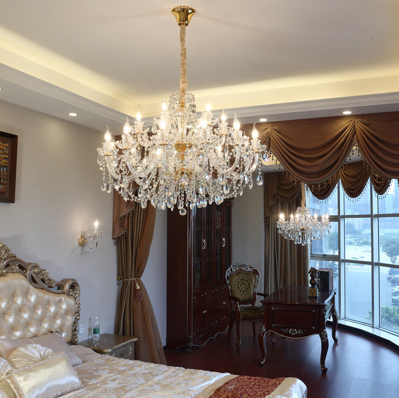 Luxurious bedroom with crystal chandelier, large window, and elegant furniture.