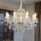 Crystal chandelier hanging in a room with a neutral color scheme