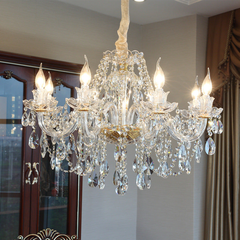 Crystal chandelier hanging in a room with a neutral color scheme