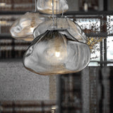 Close-up of a modern pendant light with textured glass shade in an indoor setting.