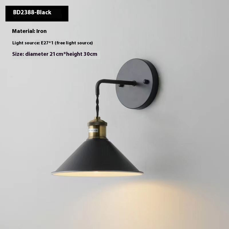 Black wall lamp with brass accents on a white background