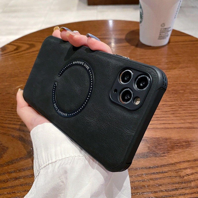 Black phone case held by a hand on a wooden table with a Starbucks cup in the background