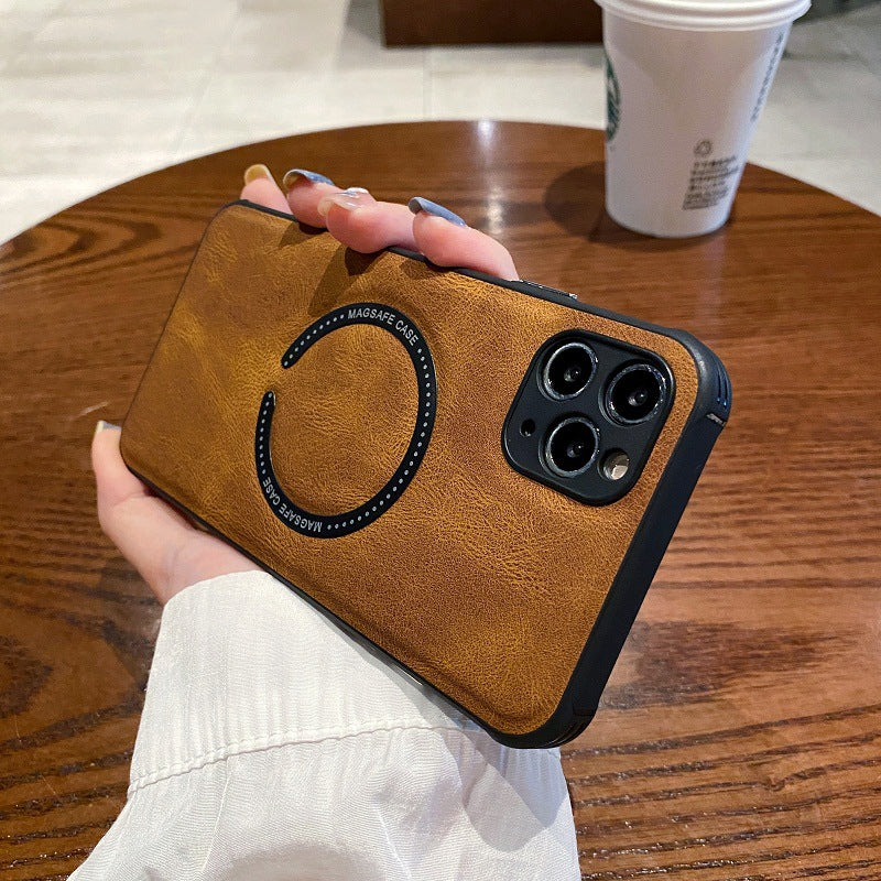 Brown phone case held by a hand on a wooden table with a Starbucks cup in the background