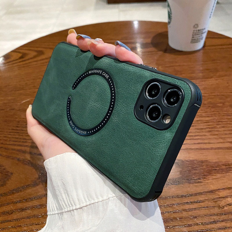 Green phone case held by a hand on a wooden table with a Starbucks cup in the background