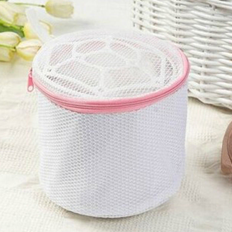 White mesh laundry bag with pink zipper on a light background