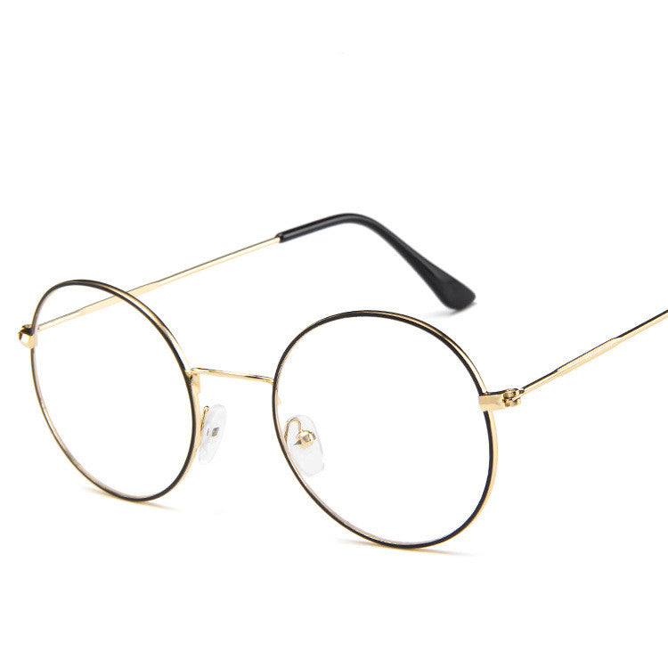 Round eyeglasses with gold frame and black arms on a white background
