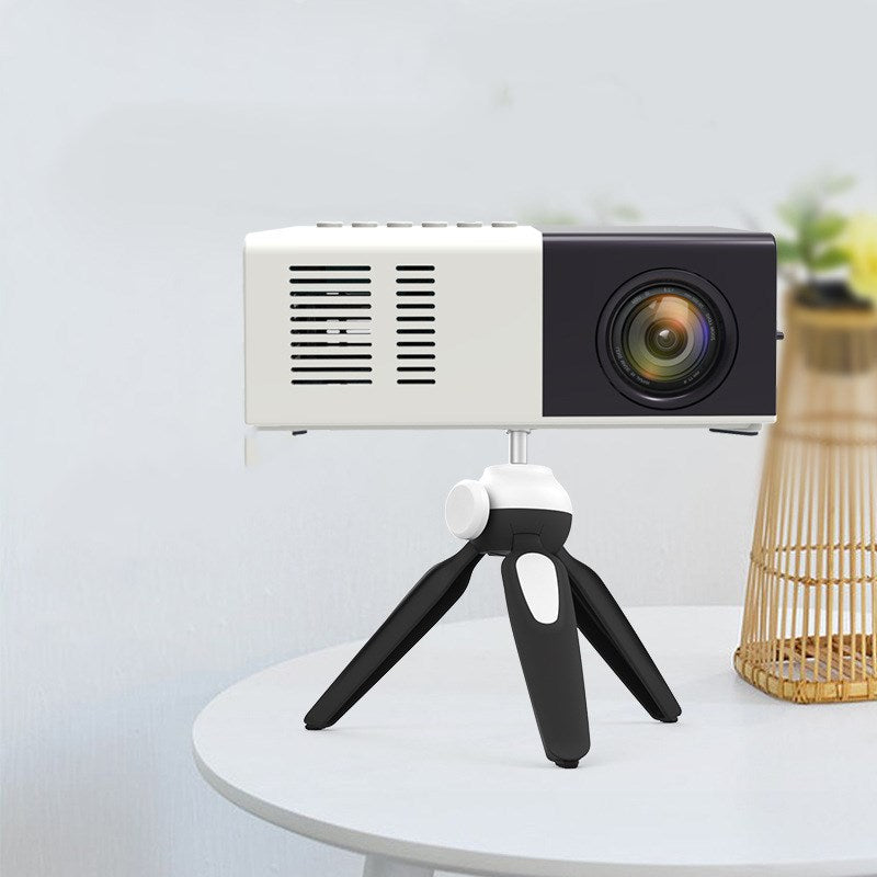 Small projector on a tripod with a white background