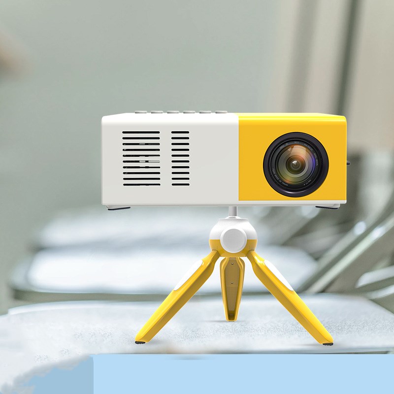 Yellow and white portable projector on a stand with a blurred background