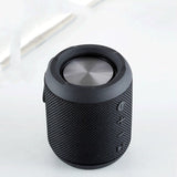 Black textured Bluetooth speaker on a white background