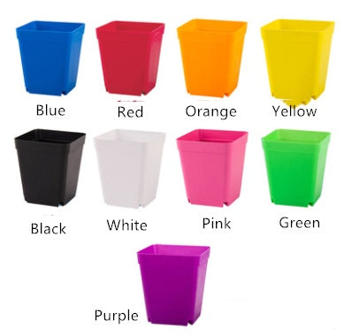 Set of colorful square plastic planters on a white background