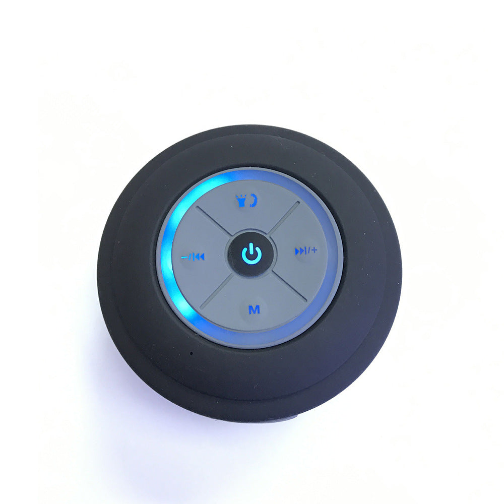 Round black control with blue LED lights on a white background