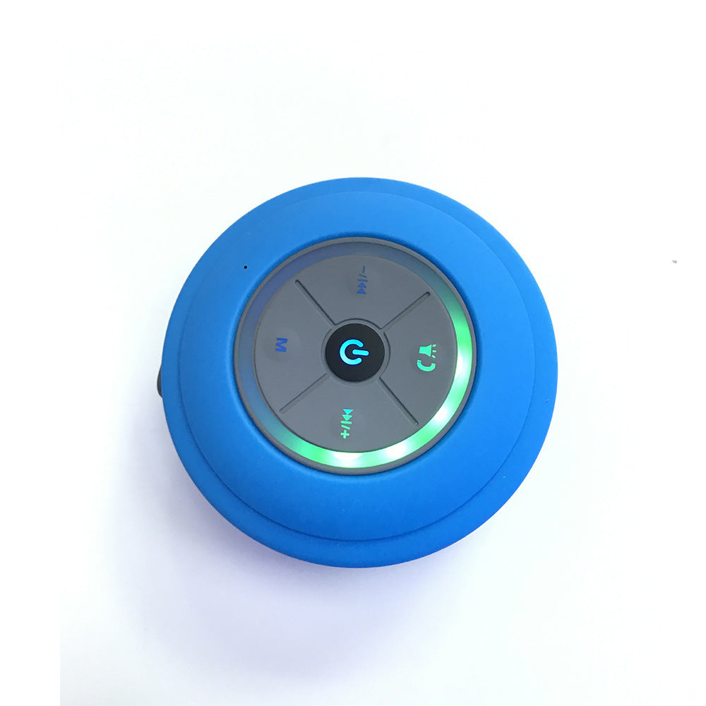 Blue round Bluetooth speaker with control buttons on a white background
