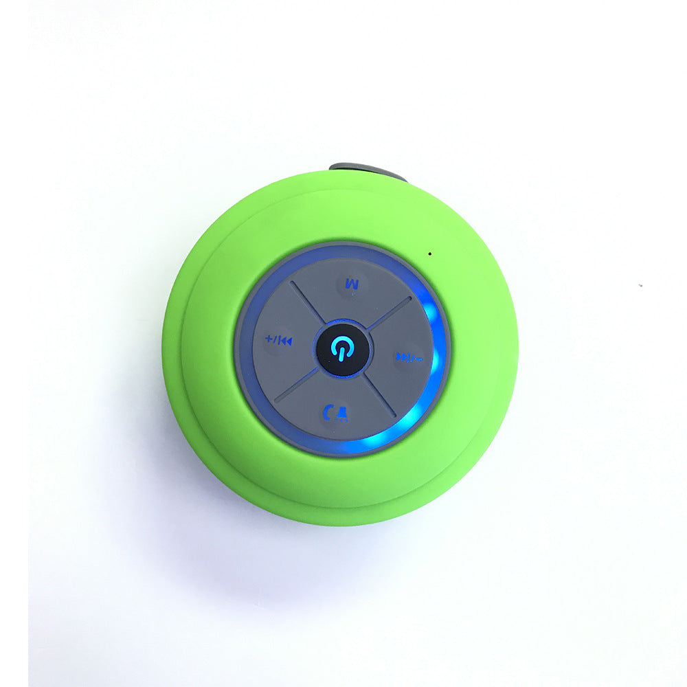 Green Bluetooth shower speaker with control buttons on a white background