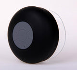 Black shower speaker with control buttons on a white background