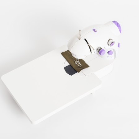 White sewing machine with a white background