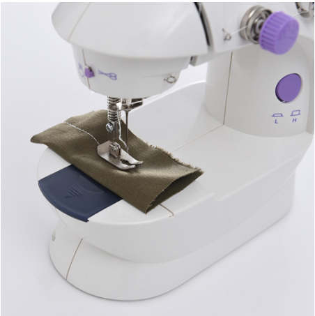 White sewing machine with brown fabric on a white background