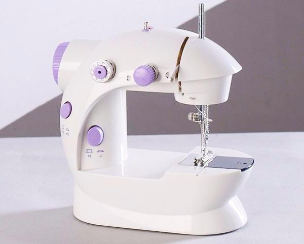 White and purple sewing machine on a light gray background