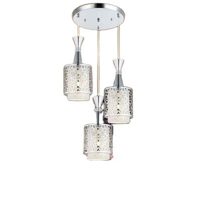 Modern ceiling light fixture with three crystal-like lampshades on a white background