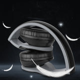 Black and gray headphones on a dark background with celestial elements