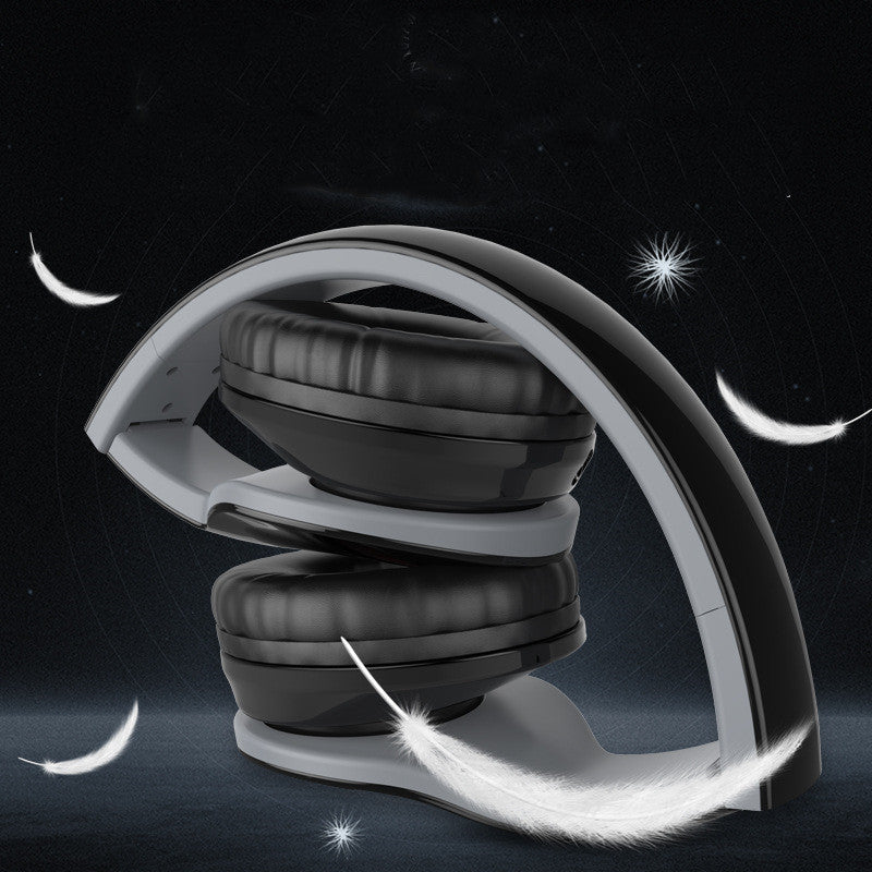 Black and gray headphones on a dark background with celestial elements