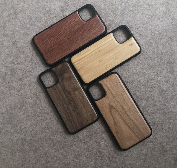 Four wooden phone cases on a gray surface