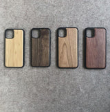 Four wooden phone cases on a gray surface