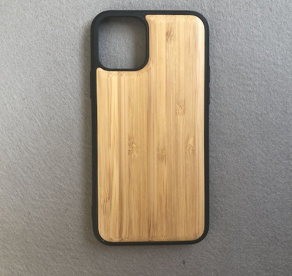 Wooden phone case with black border on a gray background