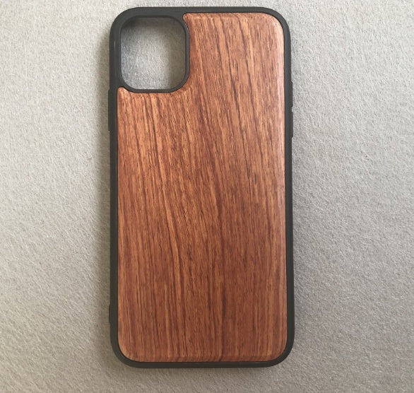 Wooden phone case with black border on a light gray background