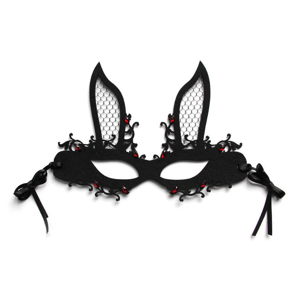 Black lace mask with red embellishments on a white background