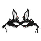 Black lace mask with red embellishments on a white background