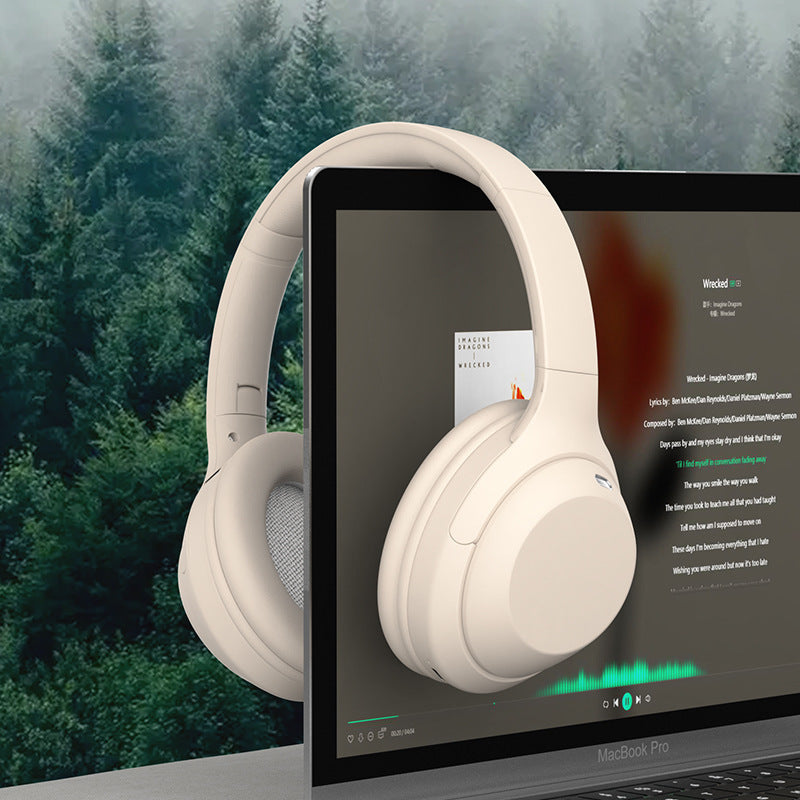 White headphones displayed on a laptop screen with a forest background