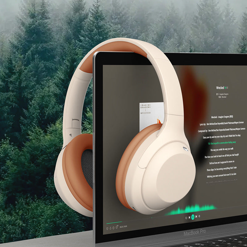 White headphones displayed on a laptop screen with a forest background