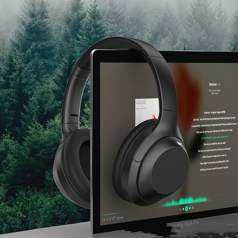 Black headphones displayed on a laptop screen with a forest background