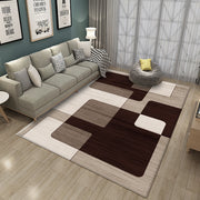 Living room with a checkered brown and beige rug, gray sofa, and decorative pillows.