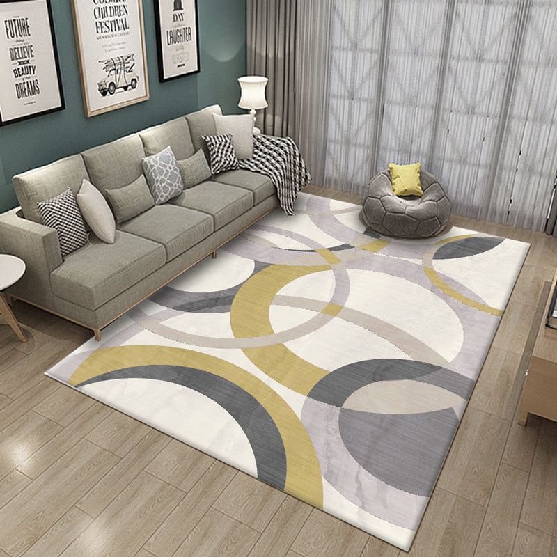 Living room with a geometric patterned rug, gray sofa, and bean bag chair.