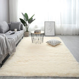 Living room with a beige rug, gray sofa, and decorative elements.