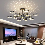 Modern chandelier in a living room with a Christmas tree and TV.