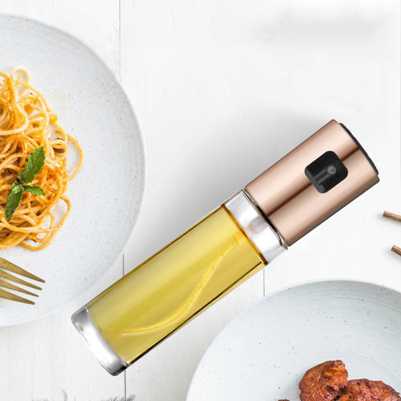 Oil sprayer with a plate of spaghetti and meatballs on a white background