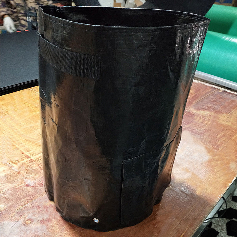 Black trash bag on a wooden surface with a blurred background